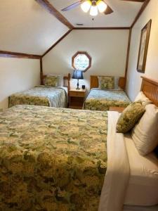 a bedroom with two beds and a window at Luxury Cabin #21 With Hot Tub and Jacuzzi on Patoka Lake in Southern Indiana in Paoli +11 photos