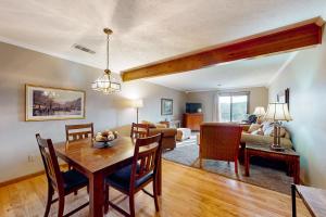 a dining room and living room with a table at Minutes from Everything in Branson