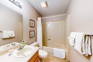 a bathroom with a sink and a toilet and a shower at Minutes from Everything in Branson