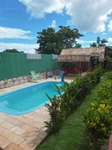 a swimming pool in a yard next to a building at Pousada Brasil - São Miguel do Gostoso in São Miguel do Gostoso