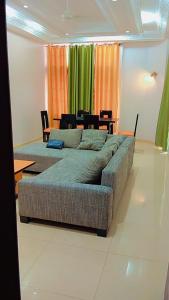 a living room with a large couch and a table at Timba Miché04 in Cotonou