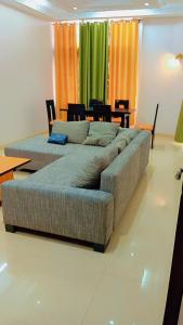 a large couch in a living room with a table at Timba Miché04 in Cotonou