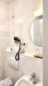 a bathroom with a phone on the wall next to a sink at Hotel Greate Pier in Kimswerd