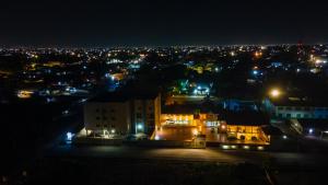 a city lit up at night with lights at Royal N Hotel in Accra