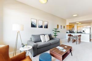 a living room with a couch and a table at Putnam Pointe Perch #510 in Bend