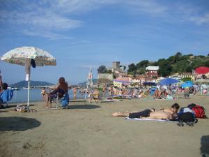 a group of people laying on the beach at Appartamento Marina in Marina di Carrara