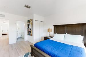 a bedroom with a large bed with a wooden headboard at Hallandale Haven in Hallandale Beach