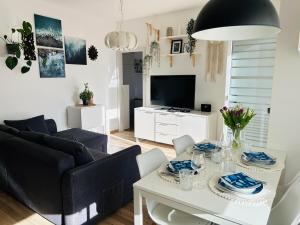 a living room with a couch and a table at Apartma VitaMia in Ankaran