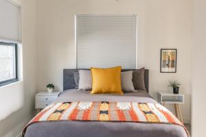 a bedroom with a bed with a yellow pillow at Tour de Fruita & EV charge point in Fruita