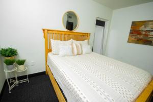 a bedroom with a large white bed with a mirror at Vintage Elegance - Condo Steps Away from Casino in Hot Springs