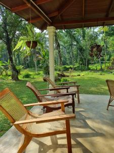 a group of chairs sitting on a patio at JAYANDRA HOLIDAY BUNGALOW in Waga