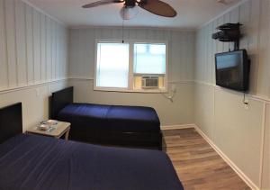 a bedroom with a bed and a tv and a couch at 6B Best Location, 4 bedrm, 2 bathrm Beach Block in Seaside Heights
