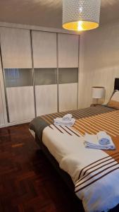 a bedroom with two beds with towels on them at The Market Square House in Faro