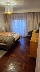 a bedroom with a bed and a desk in it at The Market Square House in Faro