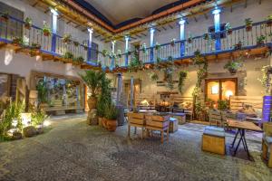 a lobby with a lot of plants on the ceilings at ARQUEOLOGO Exclusive Boutique Hotel Cusco - Centro Histórico in Cusco