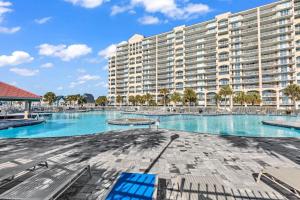 a large apartment building with a large swimming pool at Family friendly spacious Barefoot townhome in North Myrtle Beach