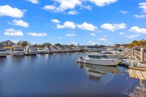 a bunch of boats are docked in a marina at Family friendly spacious Barefoot townhome in North Myrtle Beach