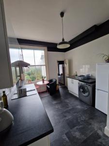 a kitchen with a sink and a stove top oven at Lovely One Bed Apartment in St Leonards in St. Leonards