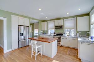 a kitchen with white cabinets and a wooden counter top at Pet-Friendly Hudson Home Near Won Dharma Center! in Hudson