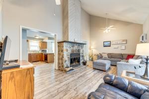 a living room with a couch and a fireplace at Arrowhead Lake Retreat with Private Indoor Pool! in Pocono Lake