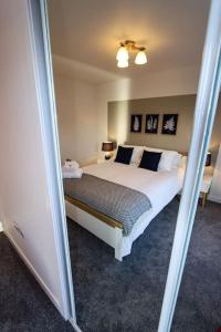 una camera con un grande letto e uno specchio di City Views by the Castle, Free Designated Parking. a Stirling