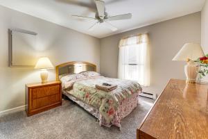 a bedroom with a bed and a table and a ceiling fan at Arrowhead Lake Retreat with Private Indoor Pool! in Pocono Lake +33 photos