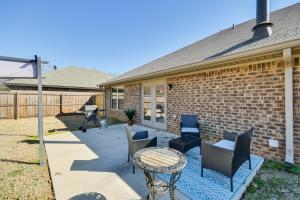 a patio with chairs and a table in front of a house at Prattville Home with Fire Pit - 2 Mi to Downtown! in Prattville