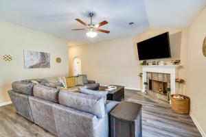 a living room with a couch and a flat screen tv at Prattville Home with Fire Pit - 2 Mi to Downtown! in Prattville