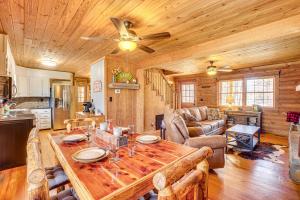 a kitchen and living room with a wooden ceiling at Cropwell Cabin with Fire Pit, Near Logan Martin Lake 
