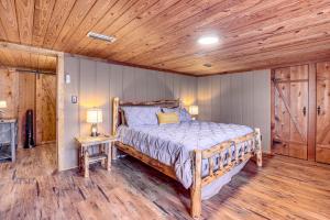 a bedroom with a bed and a wooden ceiling at Cropwell Cabin with Fire Pit, Near Logan Martin Lake 