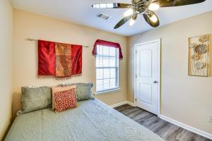 a bedroom with a bed and a ceiling fan at Prattville Home with Fire Pit - 2 Mi to Downtown! in Prattville