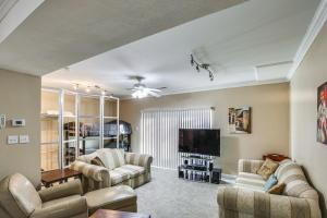 a living room with couches and a flat screen tv at St Ann Townhome Less Than 1 Mi to International Airport! in Edmundson