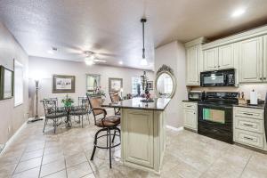a kitchen with white cabinets and a table with chairs at Pet-Friendly Dover Cottage w/ Deck + Mtn Views! in Dover