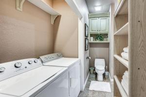 a bathroom with a washing machine and a toilet at Pet-Friendly Dover Cottage w/ Deck + Mtn Views! in Dover +19 photos