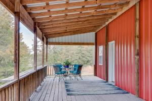 a wooden porch with a table and chairs on it at Pet-Friendly Dover Cottage w/ Deck + Mtn Views! in Dover