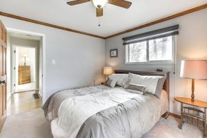 a bedroom with a large bed with a ceiling fan at Single-Story Gillette Home Walk to Lake and Trails! in Gillette