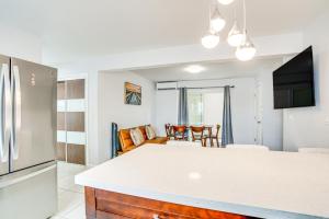 a kitchen and living room with a refrigerator at Pet-Friendly Ewa Beach Apartment about 1 Mi to Ocean! in Kapolei