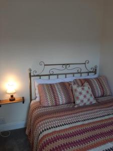 a bedroom with a bed with a lamp on a table at Salisbury Guest House - Free Parking in York