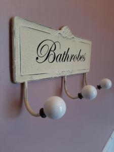a sign that says bathrooms hanging on a wall at Salisbury Guest House - Free Parking in York