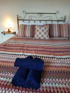 a bed with two blue towels sitting on it at Salisbury Guest House - Free Parking in York