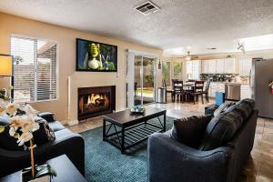 a living room with two couches and a fireplace at Vegas Getaway, Pool, Basket Ball, Games, Cook in Las Vegas