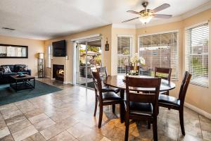 a dining room and living room with a table and chairs at Vegas Getaway, Pool, Basket Ball, Games, Cook in Las Vegas