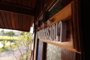 a house sign on the door of a window at DGD Chiangmai in Mae Rim