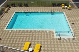 an overhead view of a swimming pool with yellow chairs at Fairfield Inn & Suites by Marriott Lawton in Lawton