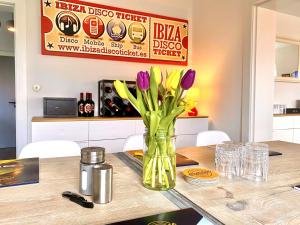 a vase of purple tulips sitting on a table at Seerose Boutique-Pension in Tating