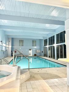 a large swimming pool in a large building at Divya Sutra Plaza and Conference Centre, Vernon, BC in Vernon