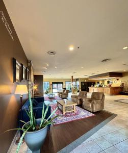 a large living room with a couch and a table at Divya Sutra Plaza and Conference Centre, Vernon, BC in Vernon