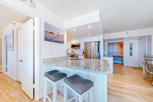a kitchen with a counter and two stools at Sea Colony --- 105 Island House Rd in Bethany Beach