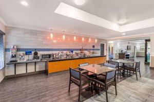 a kitchen with a table and chairs in a room at Best Western Airport Inn & Suites in Charleston