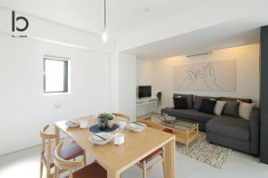 a living room with a table and a couch at b hotel Heiwaodori 1001 - Brand new Apt Famous Hiroshima dori 6p in Hiroshima